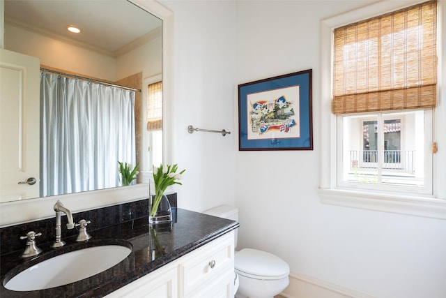 bathroom with vanity, toilet, and curtained shower