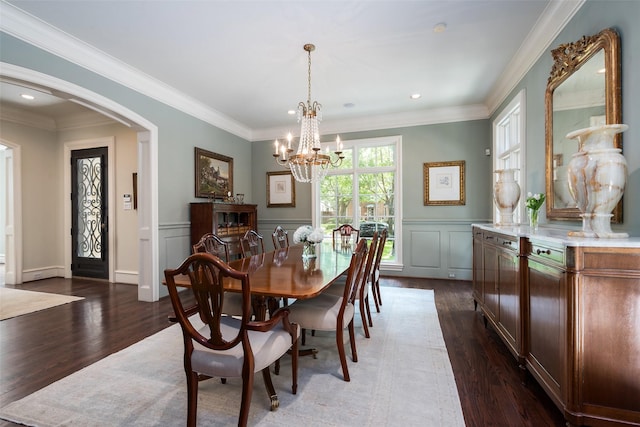 dining room featuring crown molding, a chandelier, and dark hardwood / wood-style flooring