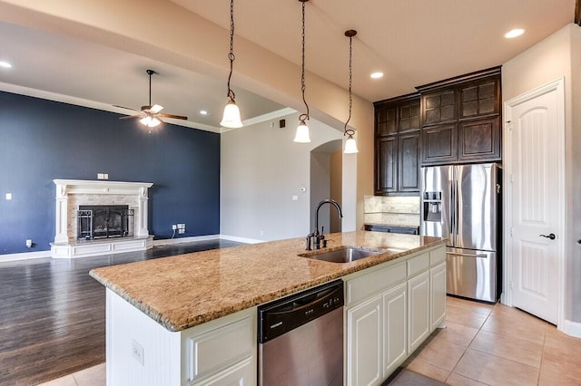 kitchen with sink, white cabinets, stainless steel appliances, and dark brown cabinets