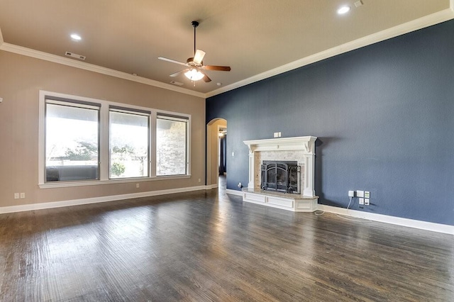 unfurnished living room featuring dark hardwood / wood-style floors, ceiling fan, and ornamental molding