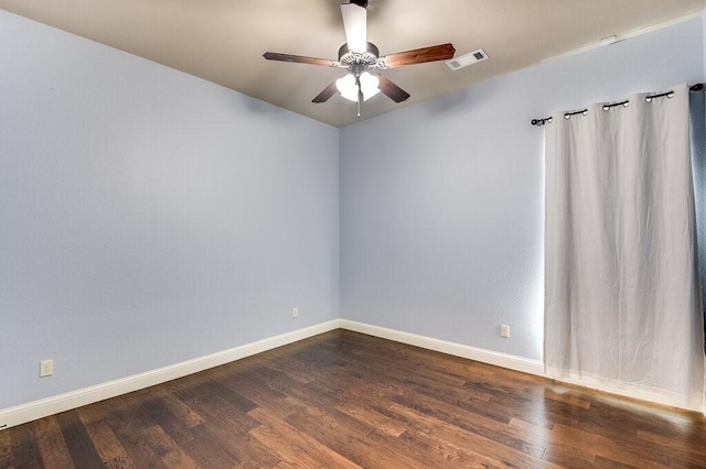 empty room with dark hardwood / wood-style floors and ceiling fan