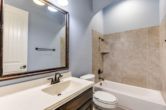 full bathroom with vanity, toilet, and tiled shower / bath