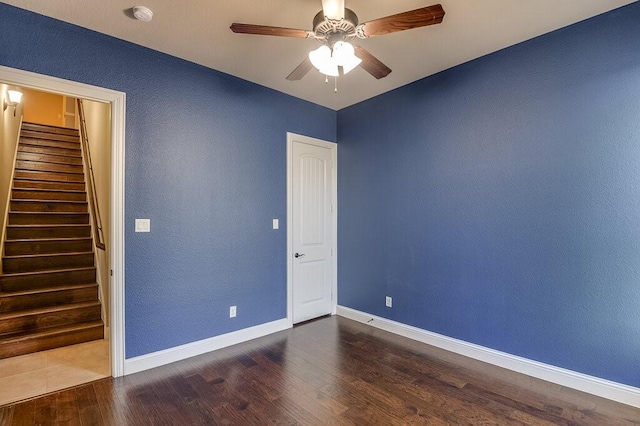 spare room featuring ceiling fan and dark hardwood / wood-style flooring