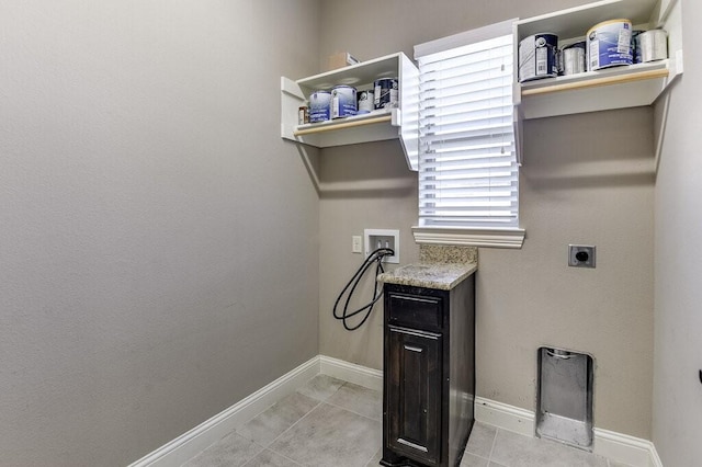 clothes washing area with hookup for a washing machine, electric dryer hookup, plenty of natural light, and light tile patterned flooring