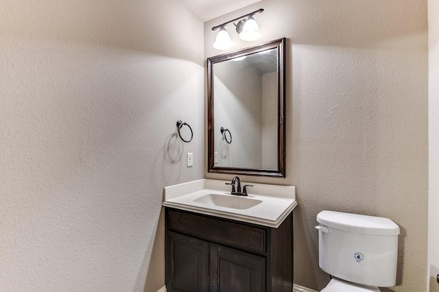 bathroom with toilet and vanity