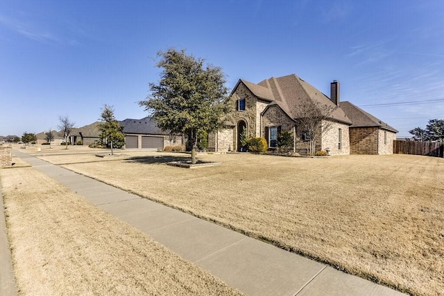 view of front of house with a garage and a front yard