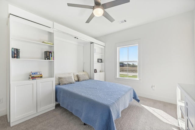 bedroom with baseboards, ceiling fan, visible vents, and light colored carpet