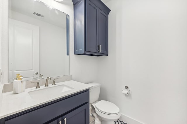 half bathroom with toilet, baseboards, visible vents, and vanity