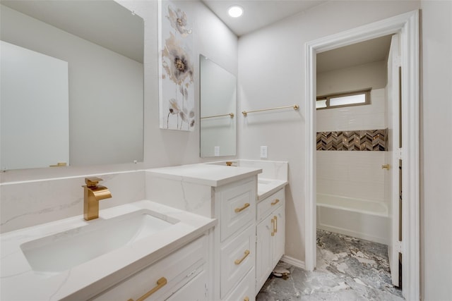 bathroom featuring tiled shower / bath combo and vanity