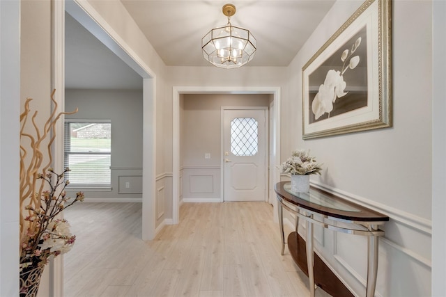 entrance foyer featuring light hardwood / wood-style floors and a chandelier