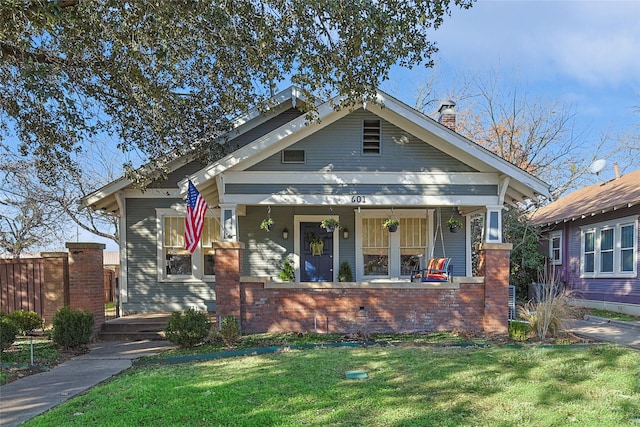 view of front of home featuring a porch and a front lawn