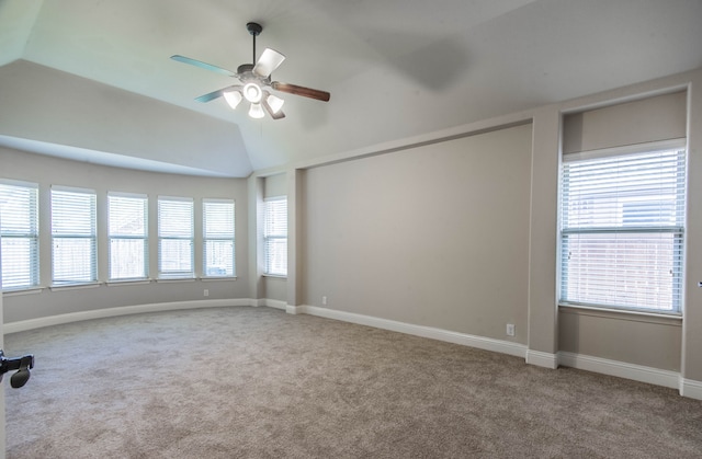 carpeted spare room featuring ceiling fan and lofted ceiling