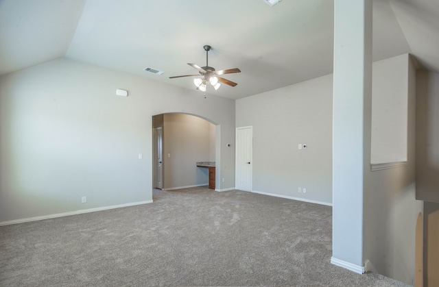 carpeted spare room with ceiling fan and lofted ceiling