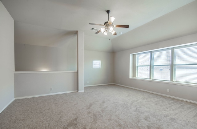 empty room with ceiling fan, light colored carpet, and lofted ceiling