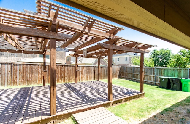 wooden terrace featuring a pergola and a yard