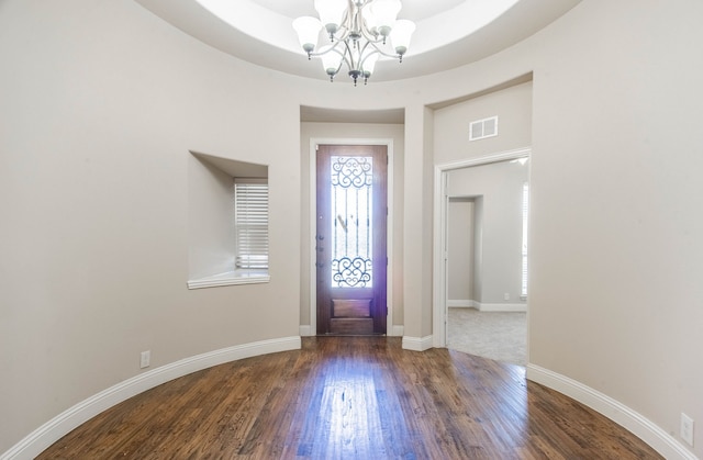 entryway featuring a notable chandelier and hardwood / wood-style floors