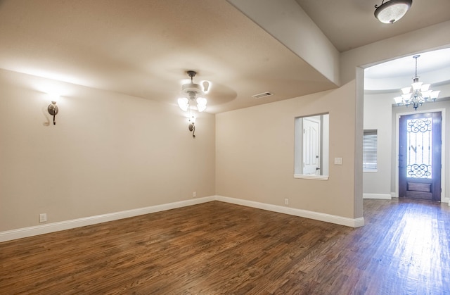 entryway with ceiling fan with notable chandelier and dark hardwood / wood-style floors