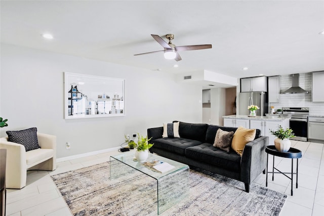 living room with ceiling fan and light tile patterned floors