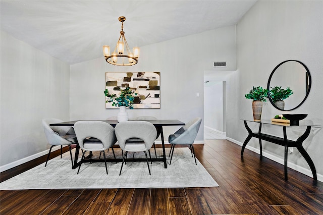 dining room featuring a notable chandelier, lofted ceiling, and dark hardwood / wood-style flooring