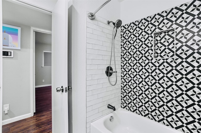 bathroom with wood-type flooring and tiled shower / bath