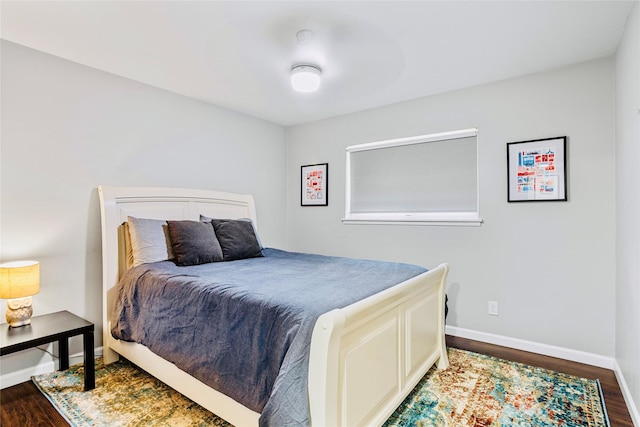 bedroom with dark hardwood / wood-style flooring