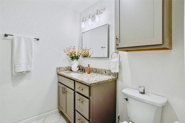 bathroom featuring vanity, toilet, and tile patterned floors