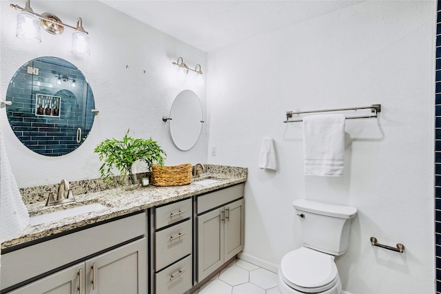 bathroom with toilet, tile patterned flooring, walk in shower, and vanity