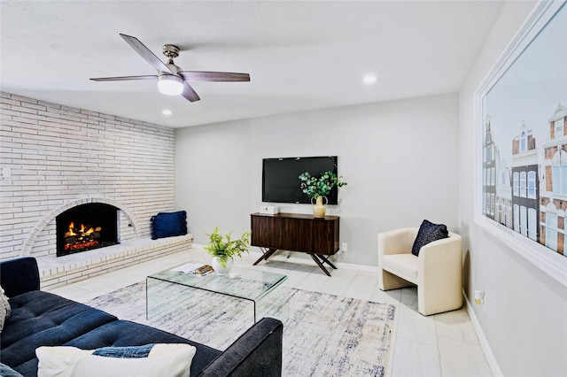 living room with a fireplace, light tile patterned flooring, and ceiling fan