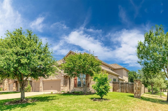 obstructed view of property featuring a garage and a front lawn