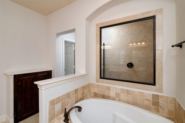 bathroom with a relaxing tiled tub