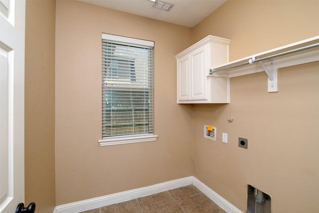 clothes washing area featuring cabinets, hookup for a gas dryer, washer hookup, hookup for an electric dryer, and light tile patterned floors