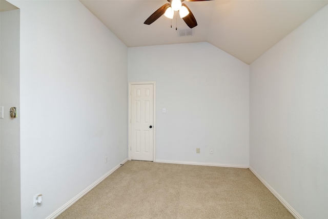 carpeted spare room with ceiling fan and lofted ceiling