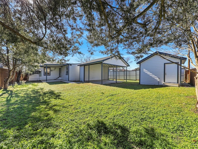 view of yard with a carport and a storage unit