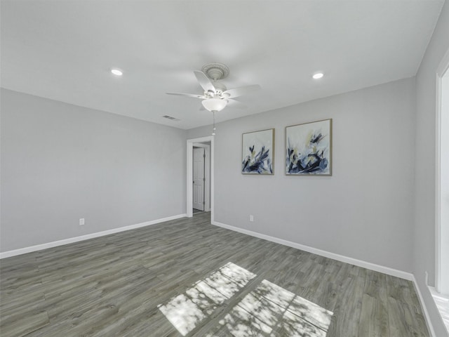 empty room featuring ceiling fan and dark wood-type flooring