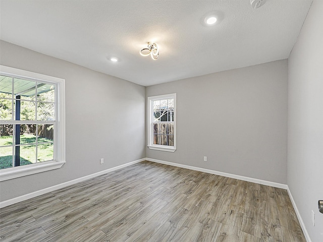 spare room with light hardwood / wood-style flooring