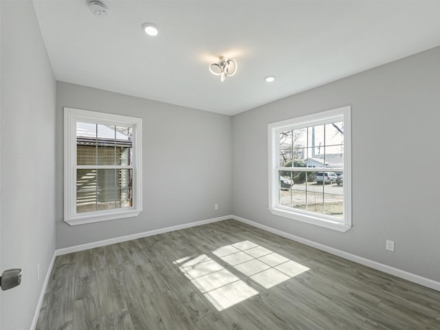 unfurnished room featuring light hardwood / wood-style floors and plenty of natural light