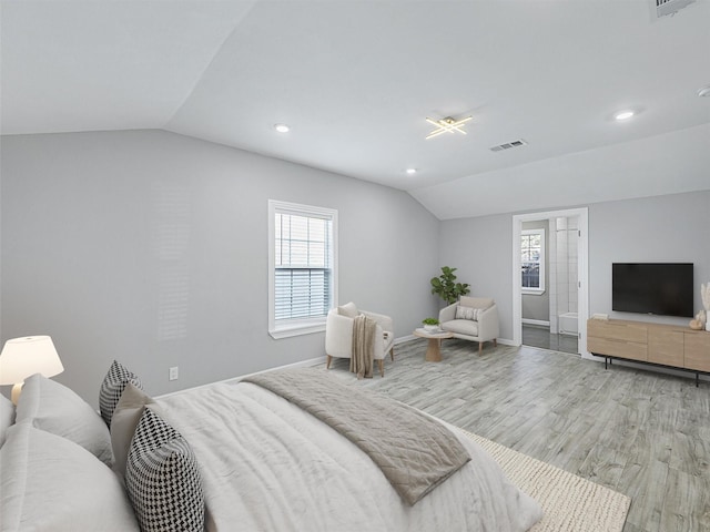 bedroom featuring light wood-type flooring and vaulted ceiling