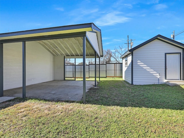 view of yard featuring an outbuilding and a carport