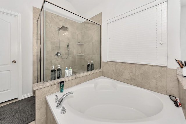 bathroom featuring vaulted ceiling and plus walk in shower