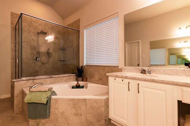 bathroom featuring tile patterned floors, plus walk in shower, vaulted ceiling, and vanity