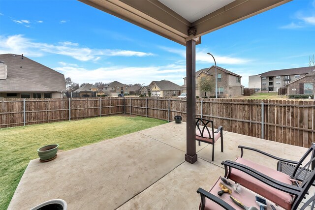 back of house with a patio and a lawn