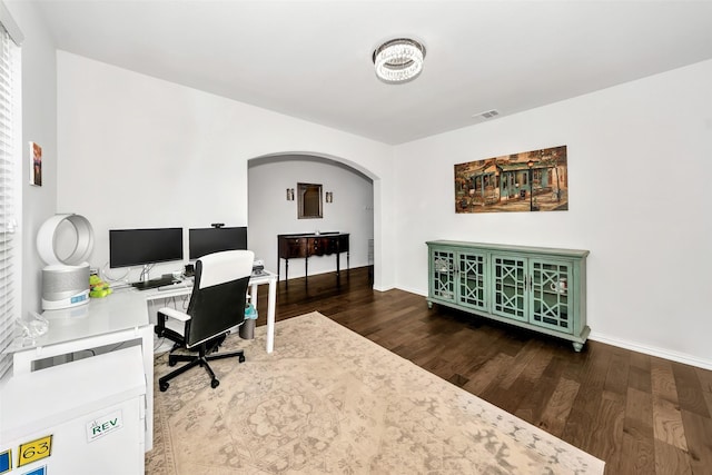 home office with dark hardwood / wood-style flooring