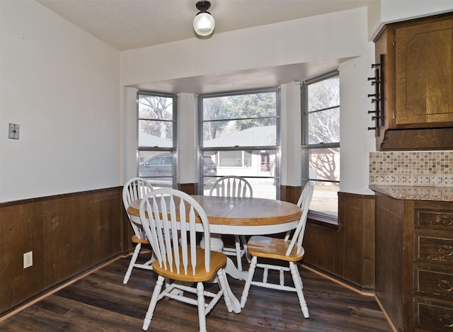 dining space with a wealth of natural light and dark hardwood / wood-style floors