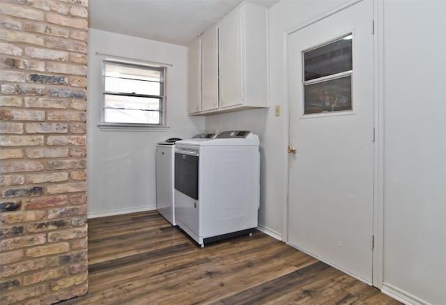 washroom with cabinets, washing machine and clothes dryer, and dark hardwood / wood-style flooring