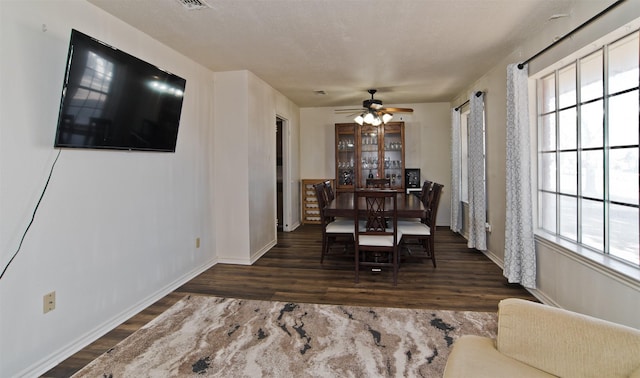 dining space with dark hardwood / wood-style floors, a textured ceiling, and ceiling fan