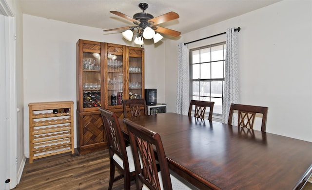 dining space featuring ceiling fan and dark hardwood / wood-style flooring