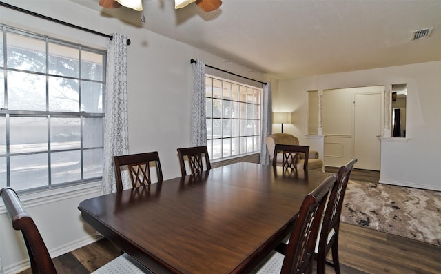 dining space featuring dark wood-type flooring and ceiling fan