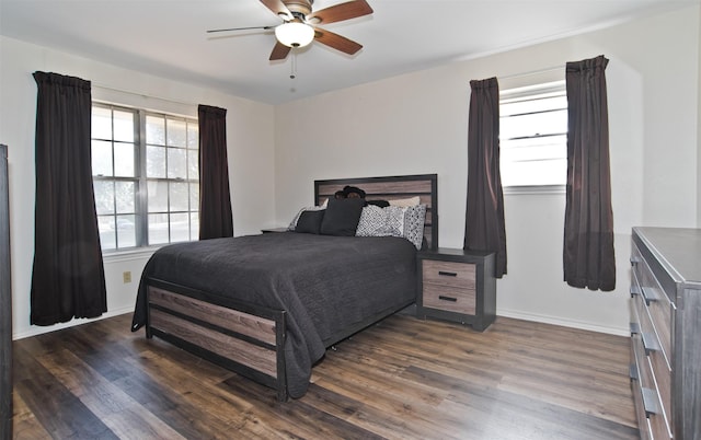 bedroom with dark hardwood / wood-style flooring and ceiling fan