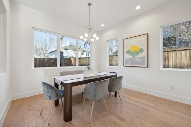 dining space featuring light wood-style floors, recessed lighting, a chandelier, and baseboards