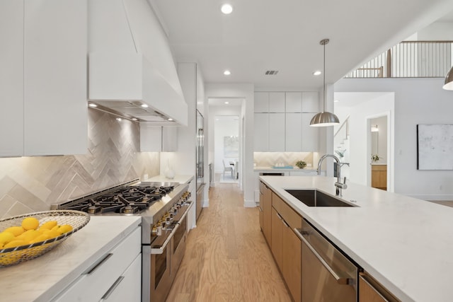 410 Kirkwood Dr, Dallas, TX 75218 - kitchen with stainless steel appliances, modern cabinets, light wood finished floors, light countertops, and recessed lighting